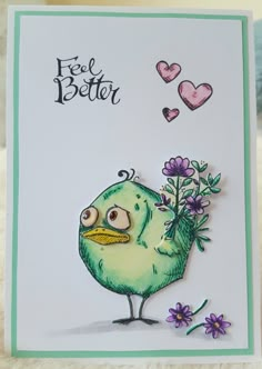 a handmade card with a green bird holding flowers in its beak and the words feel better on it