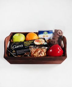 a wooden box filled with fruit and nuts