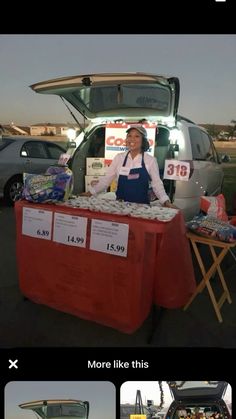 a woman standing next to a red table in front of a van