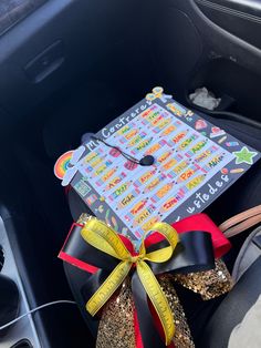 a graduation cap sitting in the back seat of a car with a ribbon around it