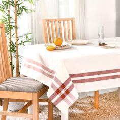 a dining room table with two chairs and a white table cloth