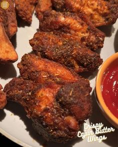 fried chicken wings on a plate with ketchup