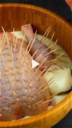 a wooden bowl filled with meat and toothpicks