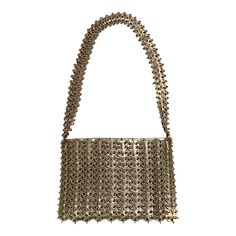 French designer Paco Rabanne is best known for his revolutionary 1968 dresses made from metal discs and rings. This rare handbag soon followed, made from the same materials. The bag has a shoulder strap, an interior silver leather pouch which has a metal zipper, a fabric lining, and the Paco Rabanne label.  It is in excellent condition, with very minor loss to the finish on three of the discs making up the shoulder strap. Measurements; Length 9"  Height 6"  Depth 1.5" Silver Chainmail Bag For Everyday Use, Designer Metallic Evening Bags, Metallic Rectangular Shoulder Bag With Chain Strap, Elegant Silver Bag With Chainmail Detail, Elegant Silver Chainmail Bag, Formal Gold Metal Shoulder Bag, Metal Shoulder Bag For Evening, Silver Chainmail Evening Bag, Luxury Metal Evening Bag