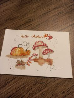 a card with an image of mushrooms and pumpkins on it, which says hello autumn