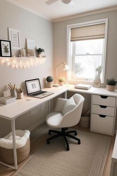 a white desk and chair in a small room with lights on the wall above it