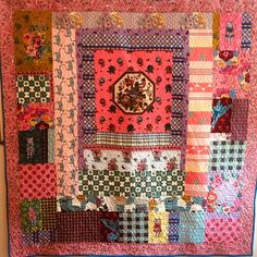 a colorful quilt is hanging on the wall