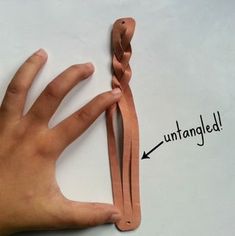 a person's hand is shown with an untangleed knot on the thumb