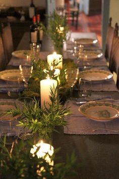 the table is set with candles and place settings