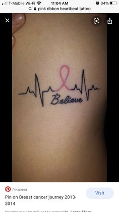 a woman's stomach with a pink ribbon and the word believe on it in black ink