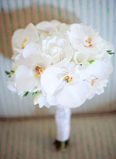 a bouquet of white flowers sitting on top of a couch