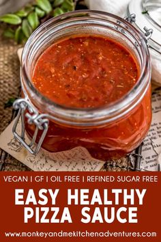 a jar filled with homemade pizza sauce sitting on top of a table