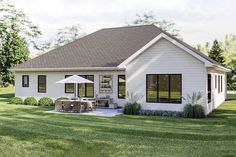 a white house sitting on top of a lush green field