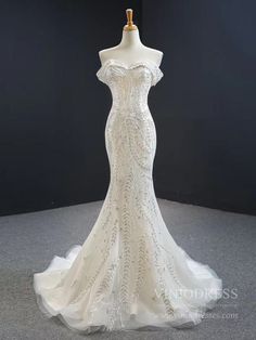 a white wedding dress on a mannequin