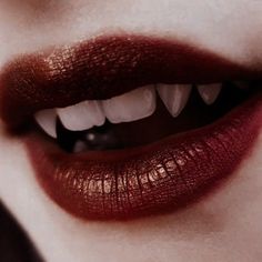 a woman's lips with white teeth and red lipstick on top of her face