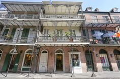 an old brick building with balconies and wrought iron railings