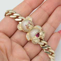 Pink Teddy Bear Cuban Link Chain Bracelet Box Lock Real 10K Yellow Gold * Metal : Real 10K Gold (Properly Stamped, 10K) * Condition : Brand New * Finish : Polished * Average Weight :  7.75" - 9mm: 16.62 grams 7.75" - 7mm: 14.37 grams * Length : Selectable * Width :  Chain: Selectable Element: 30mm x 23mm = 1 1/4" x 7/8" * Clasp/Bail : Box Lock All of our items are brand new and are shipped with a gift box. Yellow Gold Cubic Zirconia Cuban Link Bracelet For Gift, Gift White Gold Cuban Link Bracelet, White Gold Cuban Link Chain Bracelet As Gift, Gift Curb Chain Bracelet With Cubic Zirconia, Cubic Zirconia Curb Chain Bracelet Gift, Cuban Link Chain Gold Bracelet As Gift, Cuban Link Gold Chain Bracelet As Gift, Gold Chain Bracelet With Cubic Zirconia As Gift, Rose Gold Cuban Link Bracelet As Gift