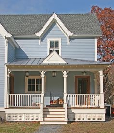 a blue house with white trim and front porch