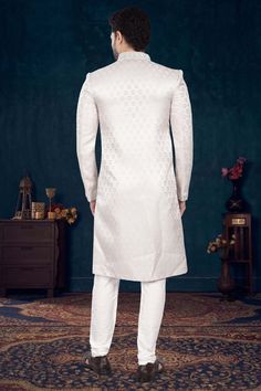 Make a statement with our Mens Sherwani- V2-S041! Perfect for grooms, this sherwani is adorned with elegant cutdana and pearls, adding a touch of sophistication to your wedding day look. Stand out from the crowd and feel like royalty on your special day. Don't miss out on this timeless piece! White Nehru Jacket For Groom With Traditional Drape, White Nehru Jacket With Traditional Drape For Groom, Traditional Wedding Sherwani With Pearl Embroidery, Reception Sherwani With Pearl Embroidery In Traditional Drape, Festive Sherwani With Pearl Embroidery, Formal Sets With Pearl Embroidery And Traditional Drape, Traditional Drape Sherwani With Pearl Embroidery For Wedding, Off White Formal Bandhgala With Traditional Drape, Elegant Off White Nehru Jacket For Eid