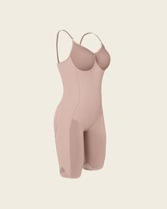 This bodysuit is the ultimate in technology, comfort, and shaping. It's made of our signature SkinFuse® fabric for moderate compression to shape your curves. Targeted compression adds a little extra shaping in the tummy and waist to gently create an hourglass effect. This bodysuit covers from the bust down to the knees and a flex-fit design at the thighs provides extra flexibility for comfortable wear. Lighter fabric in the bust and bottom prevent flattening. The bodysuit's seamless design makes Seamless Push-up Bodysuit Shapewear, Seamless Push-up Bodysuit For Shapewear, Seamless Push-up Shapewear Bodysuit, Nylon Compression Shapewear With Seamless Construction, Compressive Seamless Shapewear, Compression Shapewear Bodysuit, Compression Shapewear With Seamless Construction, Sculpting Smoothing Shapewear Bodysuit, Full Coverage Compression Bodysuit With Lined Body