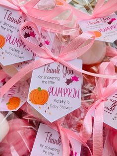 pink and orange candy bags with thank you for the pumpkin tags on them are sitting next to each other