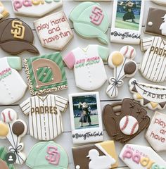 decorated cookies are arranged on a table with photos and baseball memorabilia in the shape of t - shirts