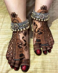 the feet are decorated with henna and jewels