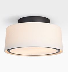 a ceiling light with a white shade on the top and black trim around the bottom