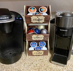 two coffee makers and one espresso machine sitting on a counter top next to each other