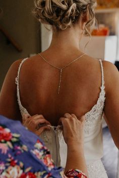 Bride Aimee Rishavy wearing a very dainty and minimal silver art deco inspired backdrop necklace made with cubic zircons on diamond-shaped setting finished with a tiny zircon drop on a chain.