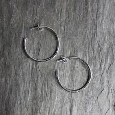 "Sterling Silver Handmade 1 1/4\" Hammered Hoops  Need a simple pair of hoop earrings on sterling silver posts?  Do you need a classic pair of handmade earrings for the woman who is hard to buy for?  These hoops are perfect for you!  Here are the details:   * These hammered hoops are made with solid sterling silver wire that is shaped and soldered onto sterling silver posts, then they are hammered for texture. These earrings are of good quality and are made with a substantial gauge wire. The hoops are about 1 1/4 inch diameter, not including the post. Hoop Earrings:  https://www.etsy.com/shop/accentyourself/?etsrc=sdt&section_id=34485221 Our Etsy Shop:  https://accentyourself.etsy.com * Your earrings will be packaged in a sturdy box inside a bubble mailer and shipped via USPS First Class M Twist Hoop Earrings, Sea Glass Ring, Hammered Hoop Earrings, Wide Band Rings, Bubble Mailer, Glass Rings, Dangly Earrings, Everyday Earrings, Hammered Silver