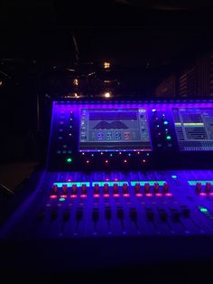 an electronic mixing board with multiple color lights