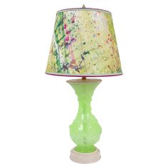 a green lamp sitting on top of a table