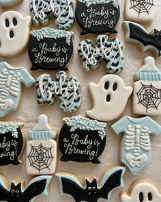 decorated cookies are arranged in the shape of bats, ghost and baby's breath