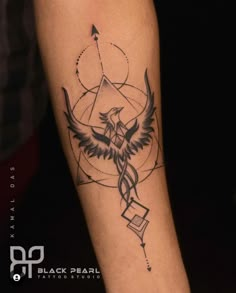 a tattoo on the arm of a person with an eagle and geometric shapes in it