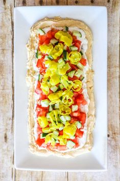 a white plate topped with a vegetable pizza