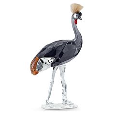 a glass figurine with a bird on it's head and feathers in its beak