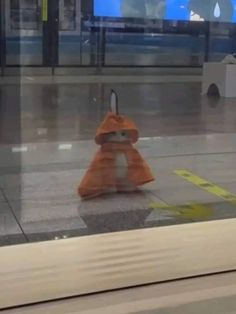 an orange cone sitting on top of a tiled floor