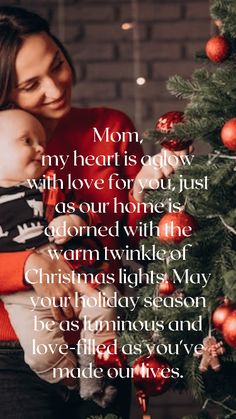 a woman holding a baby next to a christmas tree with the words mom, my heart is