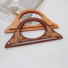 a wooden frame with an intricate design on the front and sides, sitting on a white surface