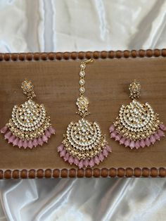 The perfect Chandbali Matching Tikka set for the upcoming season, these are made with the highest quality pachi kundan handwork that are real kundan stones. They come in 4 colors and come as a matching set of maang tikka and chandbali jhumka earrings. A statement piece to wear for weddings, sangeet, reception and mehendi etc events for the bride looking for a gorgeous timeless piece of jewelry to complete her look. It can also make as the perfect gift for any friend or bridesmaid for the festive Luxury Kundan Jhumkas With Latkans, Punjabi Earrings With Tikka, Luxury Kundan Tikka For Reception, Luxury Gold Hoop Earrings With Latkans, Luxury Tikka With Latkans For Festivals, Luxury Jhumkas With Latkans For Navratri, Hand-set Kundan Chandbalis For Festivals, Kundan Chandbali Jhumkas Hand Set, Hand Set Kundan Chandbalis For Festivals