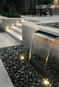 an image of a water fountain with lights on the ground and steps leading up to it