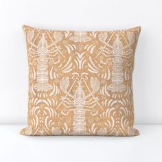 an orange and white decorative pillow on a white surface with the words, love is in the air