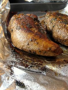 two cooked meats sitting on top of aluminum foil