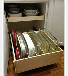 an open drawer with dishes in it