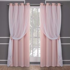 a pink curtain hanging on the side of a window