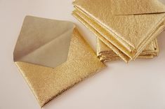 some gold paper is laying on top of each other