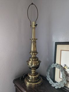 an antique brass lamp on a wooden table