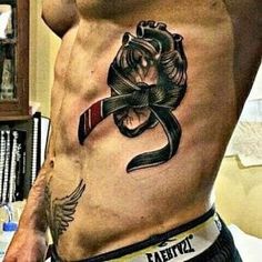 a man with a tattoo on his stomach