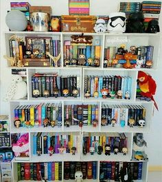 a bookshelf filled with lots of books and stuffed animals on top of it